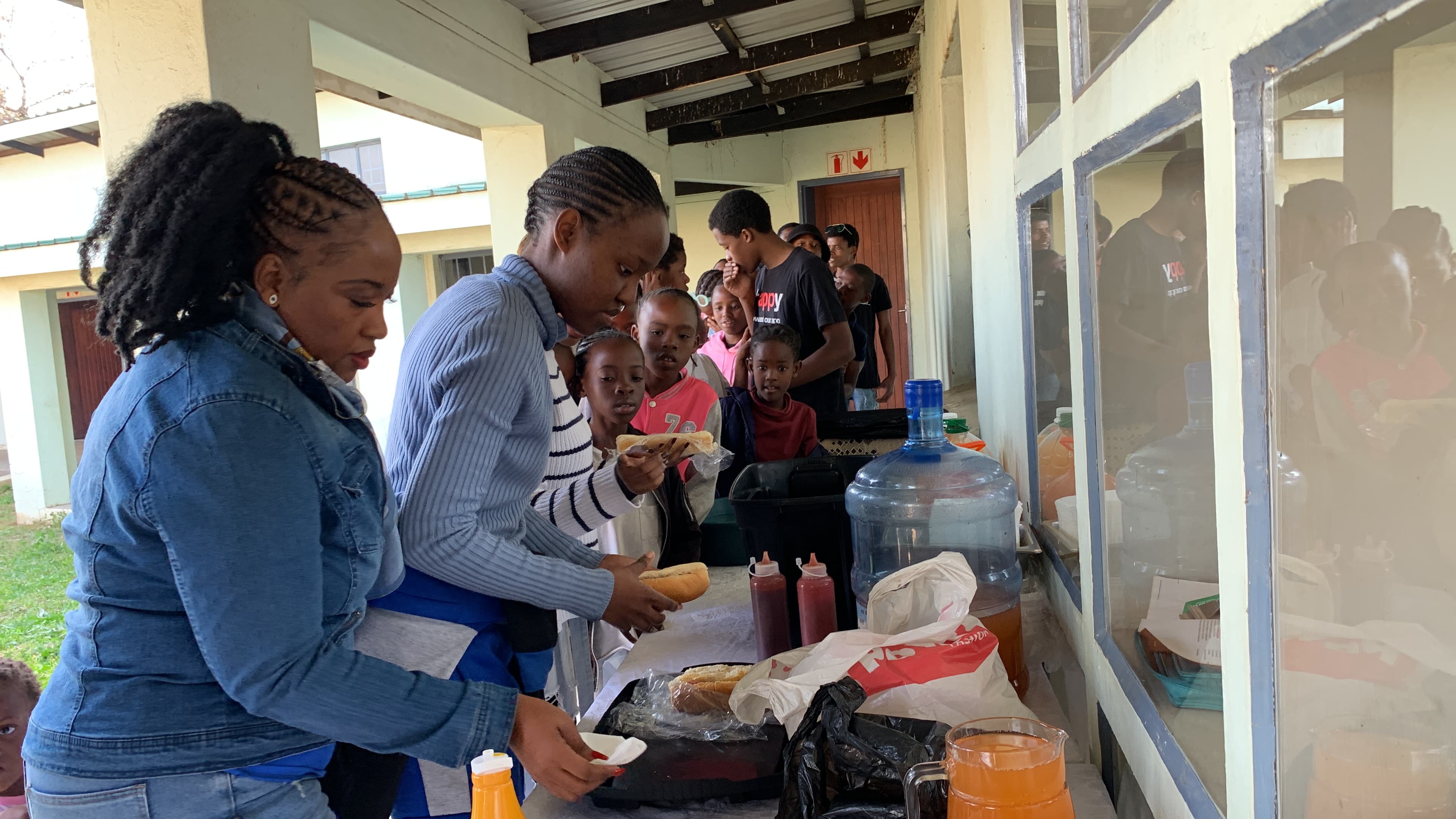Apostle Light helping serve food during community outreach